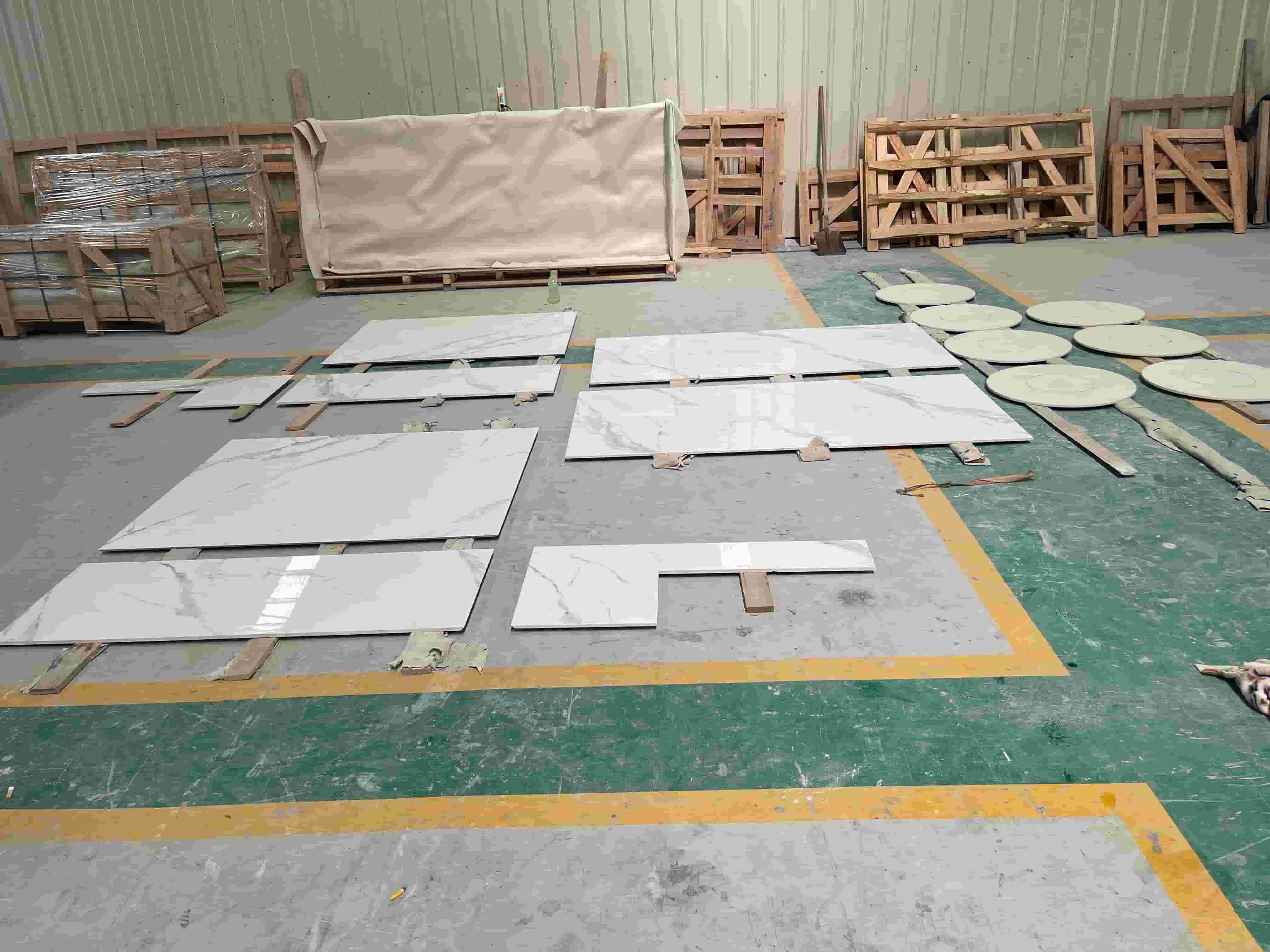 Dry layout of fabricated sintered stone countertop and backsplash pieces on factory floor