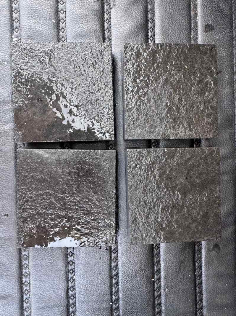 Wet water-washed Mongolian Black granite showing darker color and stronger surface contrast.