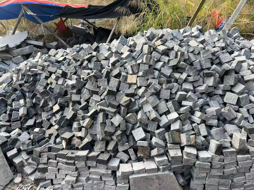 Granite cobblestones after tumbling, with softened edges and retained surface texture.