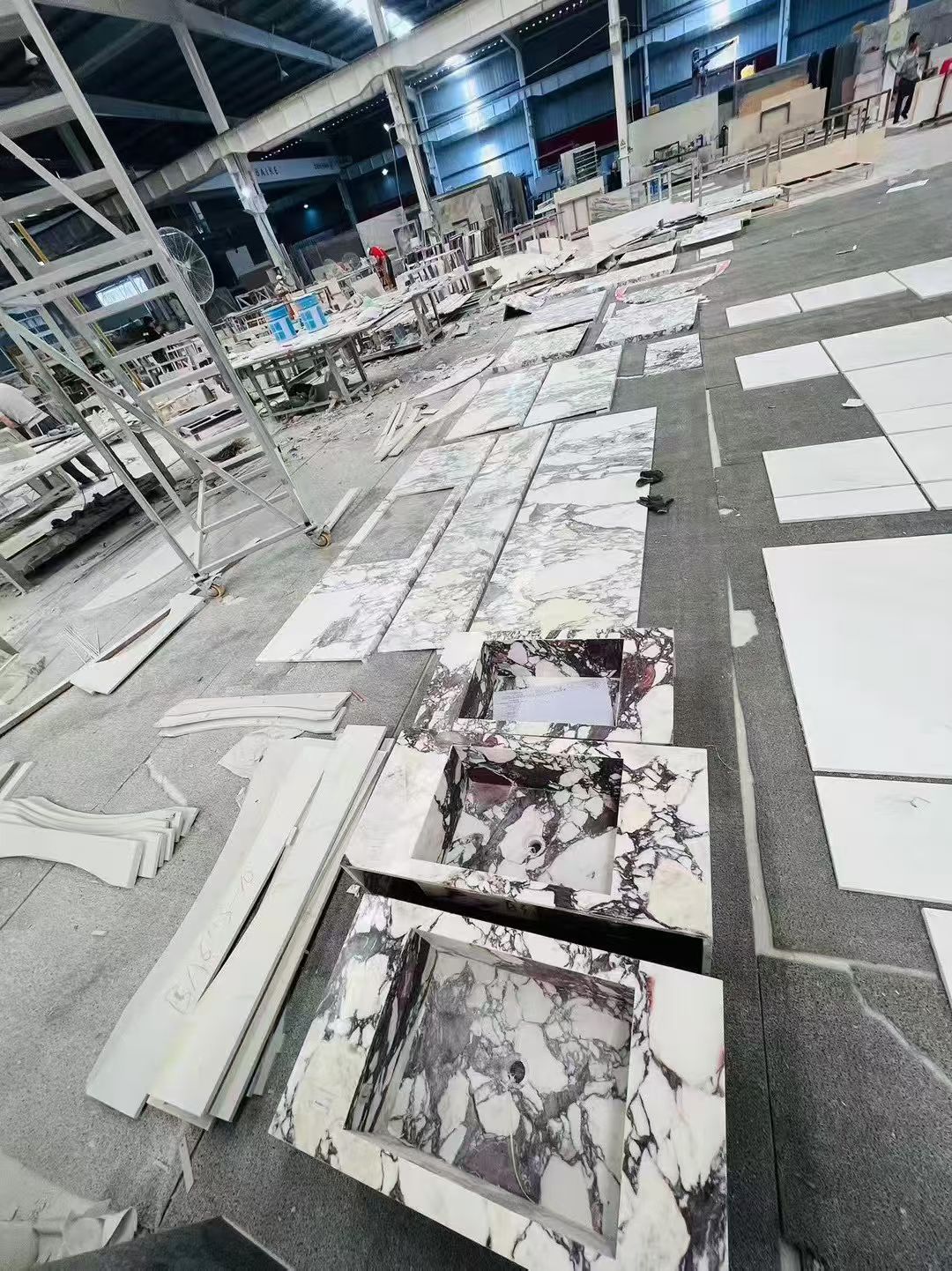 Custom Calacatta Viola marble sinks and vanity components in factory production