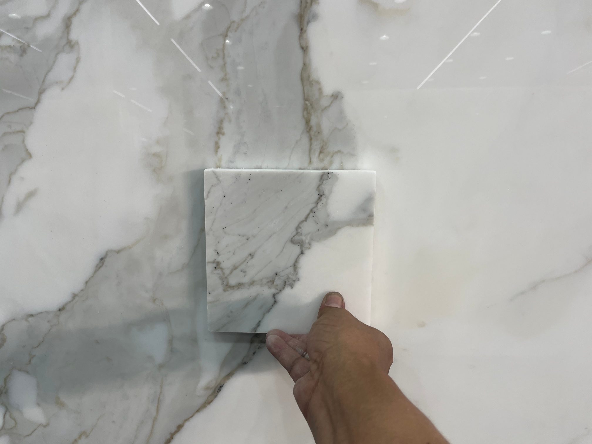 Customer Calacatta White sample matched to slab with central grey veining