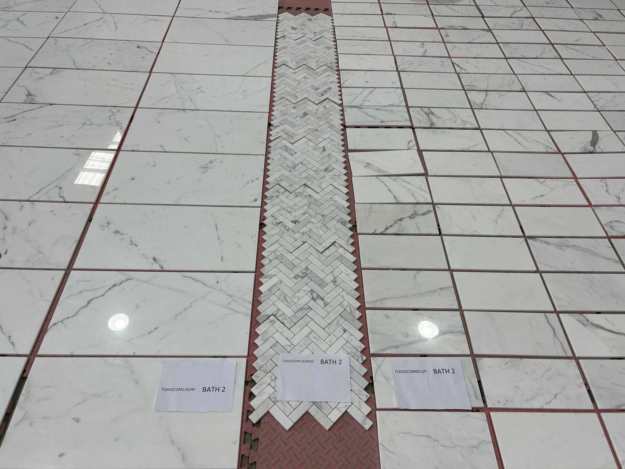 Calacatta White herringbone mosaic with custom cut-to-size marble tiles
